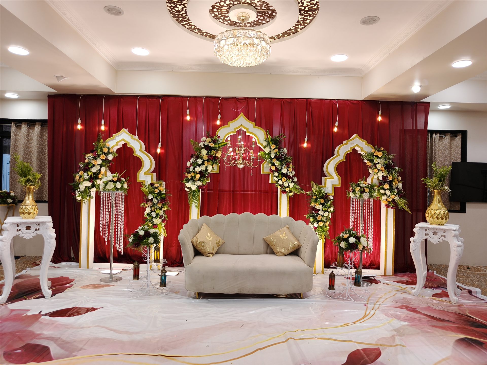 Elegant red arch wedding stage by Creative Splash Chennai